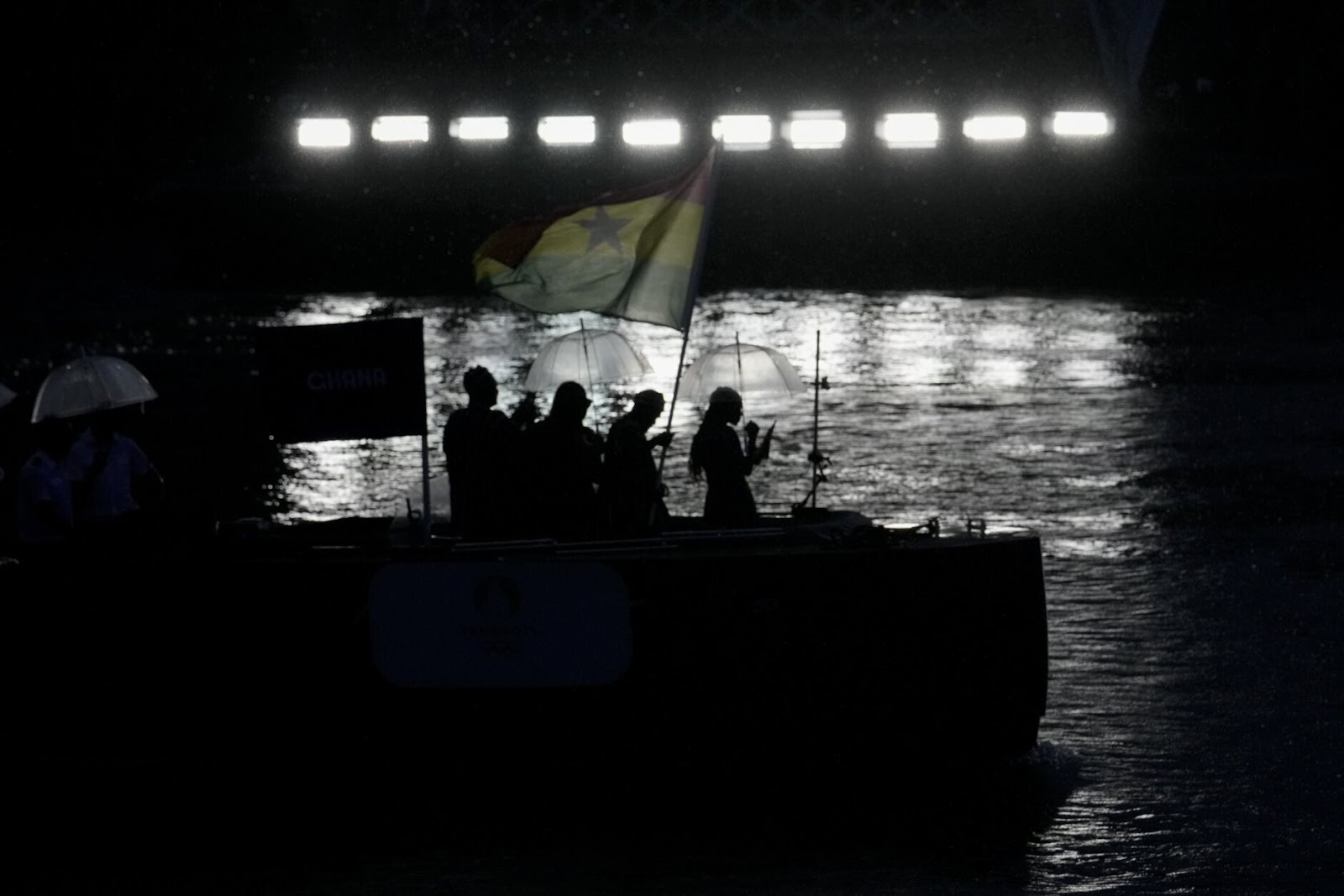 People on a boat parading the Ghana flag for the Olympic Games