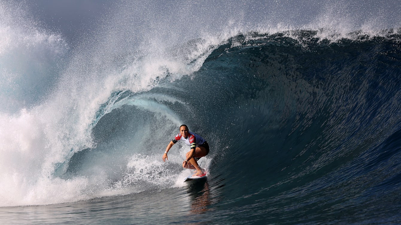 Female athlete surfing at the Olympic Games