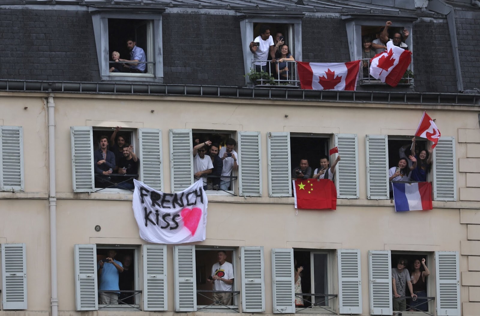 Fans waving flags from their windows